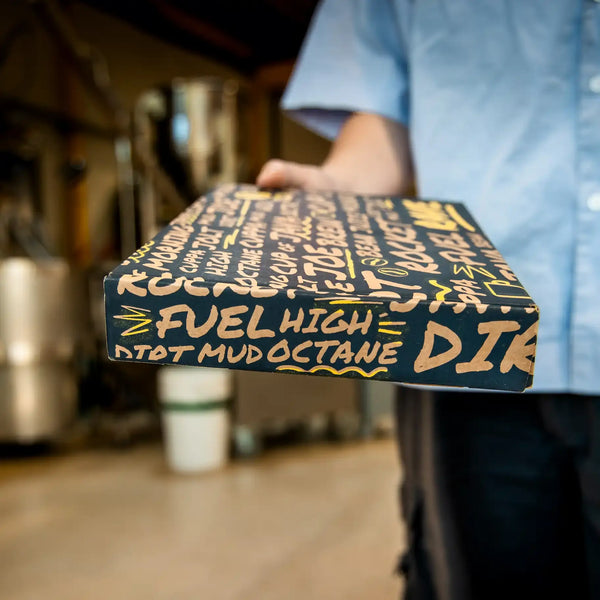 A photo of person holding a RAVE branded coffee gift box.