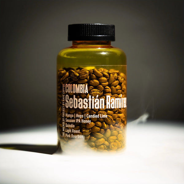 Jar of coffee beans with 'Colombia Sebastian Ramure' label on a dark background