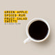 A top-down view of a white ceramic mug filled with black coffee on a warm beige background, next to yellow text that reads 'GREEN APPLE SPICED RUM FRUIT SALAD SWEETS AS A BLACK FILTER'.