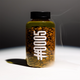 A clear cylindrical bottle filled with roasted coffee beans and a dark liquid, topped with a black cap. Large white vertical text on the bottle reads “COFFEE.