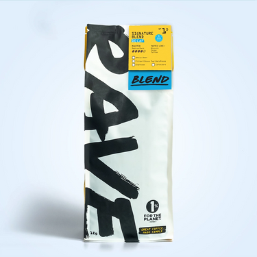 A 1kg bag of Signature Blend Decaf N° 1D coffee with bold black “RAVE” text, a yellow top label, and a “1% for the Planet” badge on white. Naturally water decaffeinated using the Swiss water process.