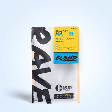 A bag of Signature Blend Decaf N° 1D features bold black and blue text on white and yellow packaging, is naturally water processed, supports 1% for the Planet, and suits filter, French press, and espresso.