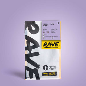 A bag of Mocha Java Blend Nº 3 coffee beans on a lavender background. The white packaging with bold black text and a yellow label highlights 1% for the Planet and Great Coffee, Made Simple—ideal for bold coffee lovers.