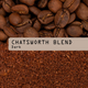 A close-up of whole coffee beans above ground chocolate coffee, divided by a beige label reading Chatswood Blend Nº 6, Dark in black letters.