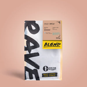 A 300g bag of RAVE COFFEE’s Cold Brew Ground Coffee Nº. 9, designed for iced coffee, with bold black and yellow text in a minimal style and a “1% for the Planet” label set against a soft pink background.