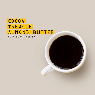 White mug with dark liquid on a beige background, text overlay 'Cocoa Treacle Almond Butter'.