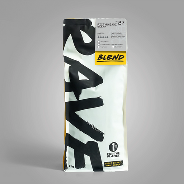 A 1kg bag of Coffee Blend 27 by Coffee Bean & Tea Tree, featuring a white bag with bold black brushstroke lettering and a yellow 'BLEND' label, set against a neutral gray background.
