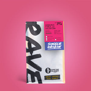 A 250g bag of Honduras Finca La Valentina Nº 391 coffee, featuring bold black lettering on a white background and a pink label with tasting notes of baked apple, cherry, and milk chocolate.