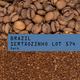 Coffee beans with a label indicating 'Brazil Sertáozinho Lot 574 Dark' on a background of ground coffee.