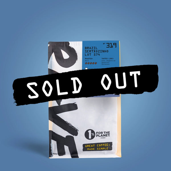 A bag of RAVE COFFEE’s Brazil Sertãozinho Lot 574 Nº 319, featuring a blue label and prominently marked with a bold black SOLD OUT banner. The packaging highlights both the 1% for the Planet commitment and the “Great Coffee, Made Simple” slogan. This naturally processed Brazilian coffee is renowned for its rich sweetness and smooth cocoa notes.