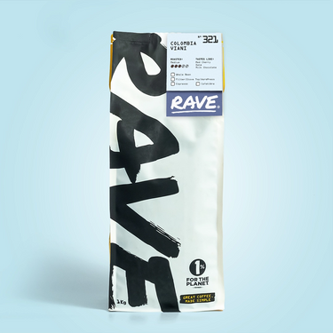 A tall white bag of RAVE COFFEE sits upright against a light blue background, featuring bold black 