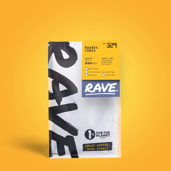 A white and yellow RAVE COFFEE bag labeled Rwanda Vunga Nº 329 features bold text, espresso and filter icons, medium roast coffee from the Vunga washing station, and a 1% for the Planet badge on a solid yellow background.