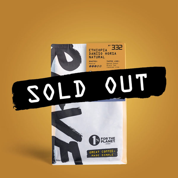 A bag of RAVE COFFEE’s Ethiopia Daniso Horsa Natural Nº 332, marked SOLD OUT, sits on a mustard yellow background. The bag features the 1% for the Planet and Great Coffee, Made Simple logos.
