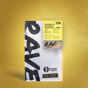 A bag of RAVE COFFEE’s Indonesia Sesongot Anaerobic Honey Nº 338 features a yellow label on gold, displaying tasting notes, honey processing details, sustainability info, and bold “RAVE” branding.