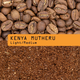 Close-up of whole Kenya coffee beans above ground coffee, centered with an orange label reading 