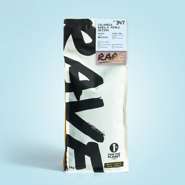 A beige and black RAVE COFFEE bag labeled RARE features Colombia Danilo Pérez Gesha Nº 347 from Huila, with tropical fruit notes and a 1% for the Planet badge on a light blue background.