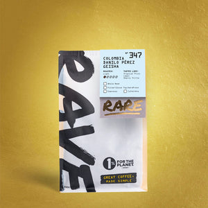 A bag of RAVE COFFEE Colombia Danilo Pérez Gesha Nº 347 features bold black text, a 1% for the Planet logo, and highlights tropical fruit notes on a gold textured background from this premium Huila Colombia gesha coffee.