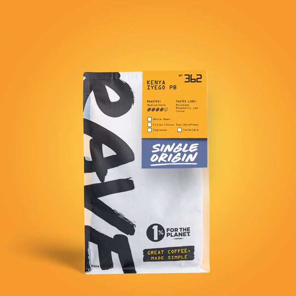 A single bag of coffee on a solid orange background. The bag is white with bold black brushstroke lettering on the left, a yellow label at the top right, and a blue label reading 'SINGLE ORIGIN' in the center.