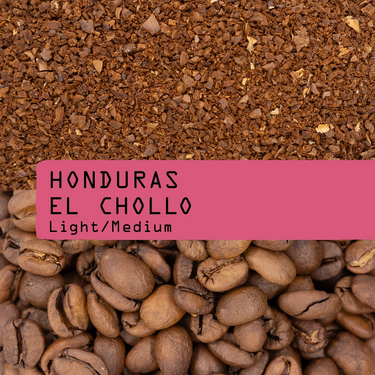 Coffee grounds and coffee beans with 'Honduras El Chollo' label on a pink background