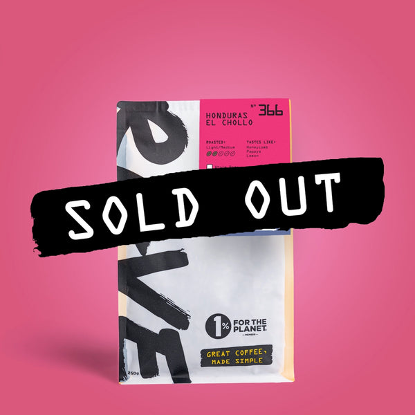 A coffee bag labeled Honduras El Chollo N°366 from RAVE COFFEE, featuring vibrant Honduran coffee, sits boldly against a pink background with a SOLD OUT banner across it. This natural coffee bag also displays 1% for the Planet and Great Coffee, Made Simple.