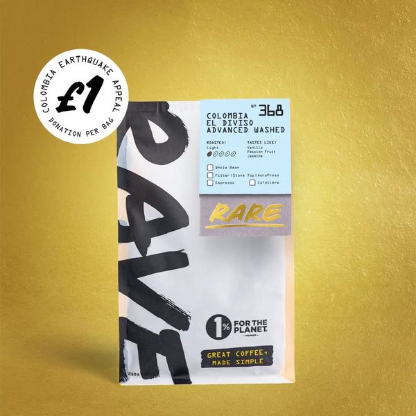 A bag of RAVE COFFEE’s Colombia El Diviso Advanced Washed Nº 368 - £1 Earthquake Relief, a single origin Colombian light roast, is prominently featured on a yellow surface with a £1 donation appeal supporting earthquake relief in Colombia. The packaging also displays the 1% for the Planet text.