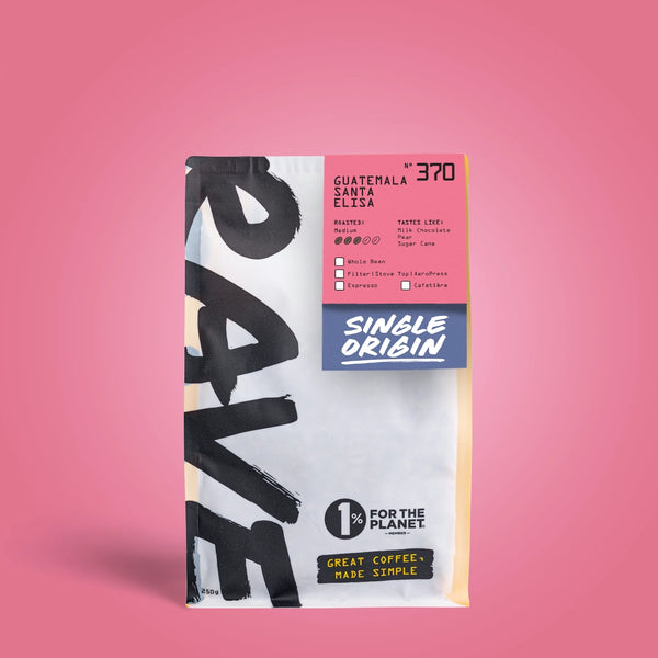 A bag of Rave Coffee Company Guatemala Santa Elisa single origin coffee, featuring a white and black design with a pink and blue label, set against a solid pink background.