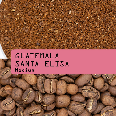 Guatemala Santa Elisa medium roast coffee beans shown above ground coffee, with a pink label overlay reading 'GUATEMALA SANTA ELISA Medium'.