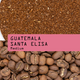 Guatemala Santa Elisa medium roast coffee beans shown above ground coffee, with a pink label overlay reading 'GUATEMALA SANTA ELISA Medium'.