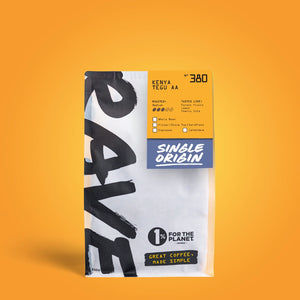 A single bag of Rave Coffee Kenya Tegu AA coffee, featuring a white bag with bold black brushstrokes and a bright orange and blue label, set against a solid orange background.