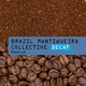 A close-up product graphic showing coffee beans at the bottom and ground coffee at the top, with a blue label across the center reading “BRAZIL MANTIQUEIRA COLLECTIVE DECAF Medium.”.