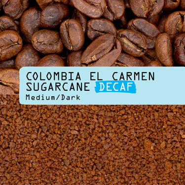 Close-up of whole coffee beans above ground coffee, blue label reads Colombia El Carmen Sugarcane Decaf Nº 77, Medium/Dark—deliciously smooth Colombian Sugarcane Decaf Coffee for a premium brew.
