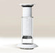 A clear and white AeroPress Premium Coffee Maker by Aerobie stands upright on a light surface, highlighting its plunger, filter cap, measurement markings, and innovative 3-in-1 brewing technology.