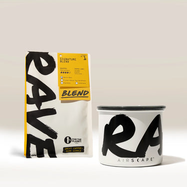 A Rave Branded Airscape with Coffee stands upright next to a coffee bag labeled Blend, both featuring bold black text against a neutral background—perfectly highlighting Rave’s dedication to fresh roasted coffee.