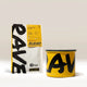A yellow and white Rave coffee bag labeled “RAVE Blend” is positioned behind a matching Rave branded Airscape coffee storage canister with bold black lettering, both set against a neutral background—perfect for keeping your fresh roasted coffee at its best. This is the Branded Airscape with Coffee by Rave.