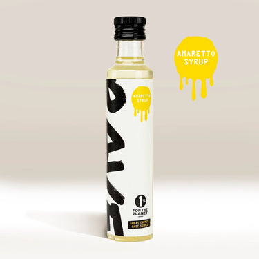 A clear glass bottle labeled RAVE COFFEE Rave Coffee Syrups stands upright with bold black text and a yellow label. Next to it, a yellow splash graphic displays the flavor. Ideal for UK coffee syrup lovers. The light background keeps the focus simple.