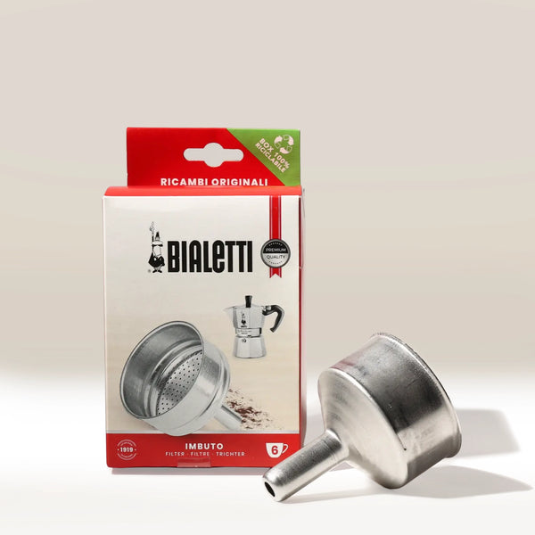 The Bialetti Funnel for Ground Coffee is shown in front of its red and white packaging, which displays the Bialetti logo, a Moka Express moka pot image, and multilingual text.