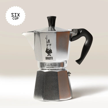 The Bialetti Moka Express Stove Top Coffee Maker by Bialetti, a silver moka pot with a black handle, is displayed against a light background. A 