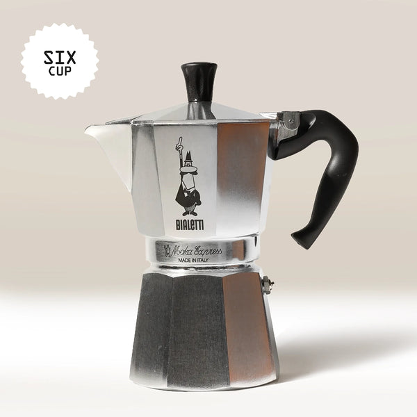 The Bialetti Moka Express Stove Top Coffee Maker by Bialetti, a silver moka pot with a black handle, is displayed against a light background. A "Six Cup" label is shown in the top left corner.