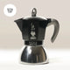 The Bialetti Moka Induction Stove Top Coffee Maker, in black and silver with a grey handle, is made in Italy, holds six cups, and is shown against a light background.