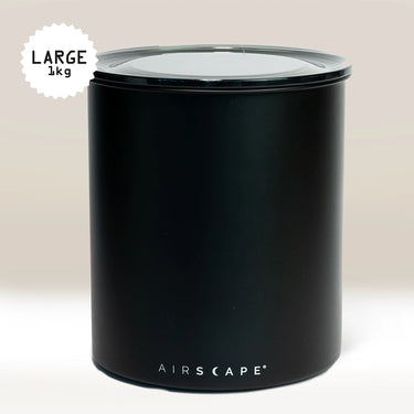The Planetary Design Black Airscape Coffee Storage Container, shown against a neutral background, features a transparent, oxygen-removing lid and a label indicating it holds 1 kg.