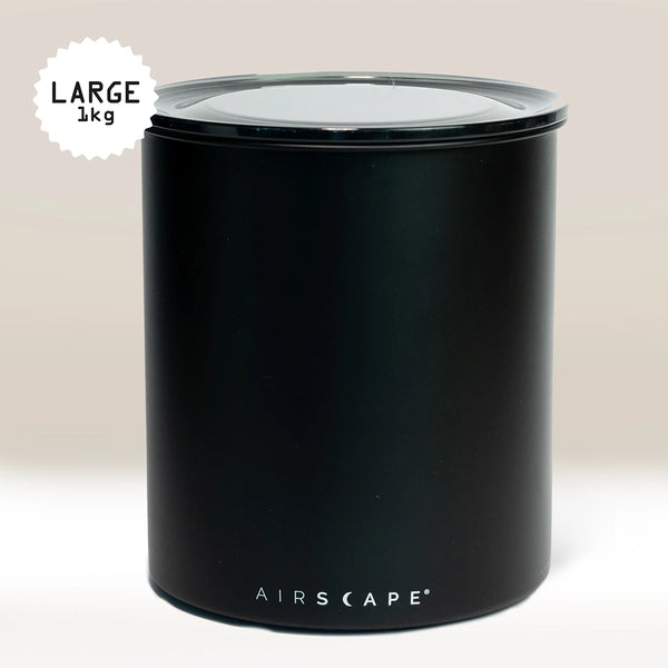 The Planetary Design Black Airscape Coffee Storage Container, shown against a neutral background, features a transparent, oxygen-removing lid and a label indicating it holds 1 kg.