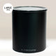 The Planetary Design Black Airscape Coffee Storage Container, shown against a neutral background, features a transparent, oxygen-removing lid and a label indicating it holds 1 kg.