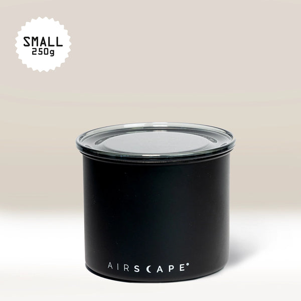 The Planetary Design Black Airscape Coffee Storage Container, featuring Airscape technology for oxygen-free storage, is shown with a transparent lid against a beige background. "SMALL 250g" is written in the upper left corner.