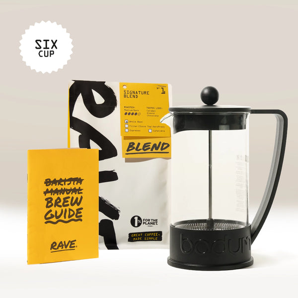 The Bodum French Press Gift Set by Bodum features a French press, a yellow brew guide, and a bag of Signature Blend Six Cup Rave Coffee, all arranged on a white background—making it the perfect coffee gift box for any enthusiast.