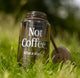 A RAVE COFFEE Rave Nalgene Bottle (1L) made from recycled plastic rests on the grass, featuring 
