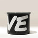 The Branded Airscape Coffee Storage Container by Rave is black with a gray lid. Bold white 