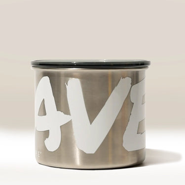 The Branded Airscape Coffee Storage Container by Rave features stainless steel, a black lid, and bold white “AVE” lettering on its surface, shown against a neutral background.