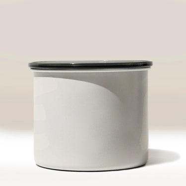 The Rave Branded Airscape Coffee Storage Container features a plain, cylindrical white design with a smooth surface and a dark flat lid, shown against a neutral background.