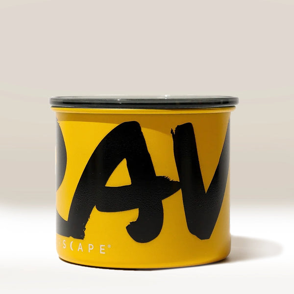 The Rave Branded Airscape Coffee Storage Container is a yellow airtight canister with a black lid, featuring large bold black letters partially spelling a word on its side against a plain light background.