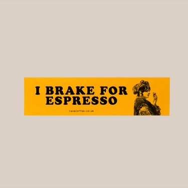 The RAVE COFFEE Car Bumper Sticker is a rectangular, yellow vinyl decal with a glossy finish. It features bold black 